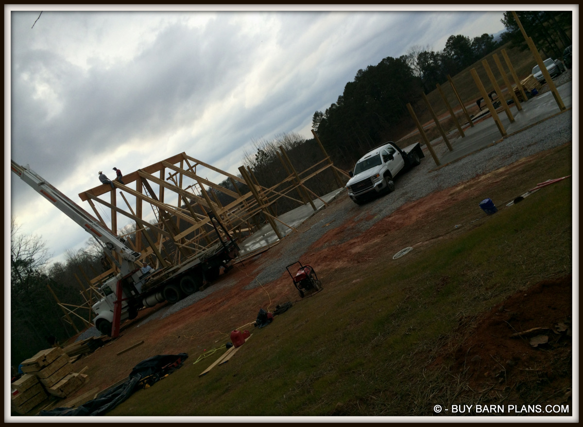 Photo Of Framing Guys Taking A Break On Top Of The Ridge 2 Ply 24 Inch LVL Ridge Being Set With A Crane White Oak Barn Home Buy Barn Plans .com Photo Of Framing Guys Taking A Break On Top Of The Ridge