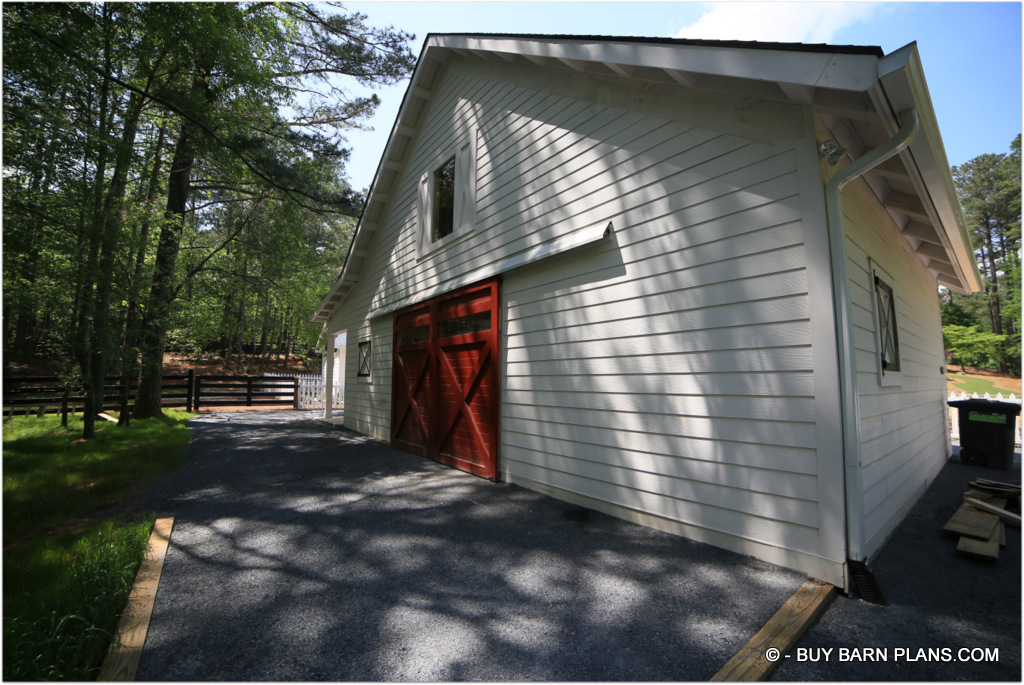 Rear Photo View On The For This 2 Stall Horse Barn With Bright Red Aisle Doors