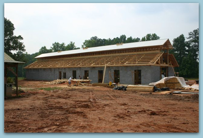 Under Construction - Photo Image View Of Twelve Stall Monitor Style Horse Barn Built With Concrete Blocks Metal Roof Over Purlins