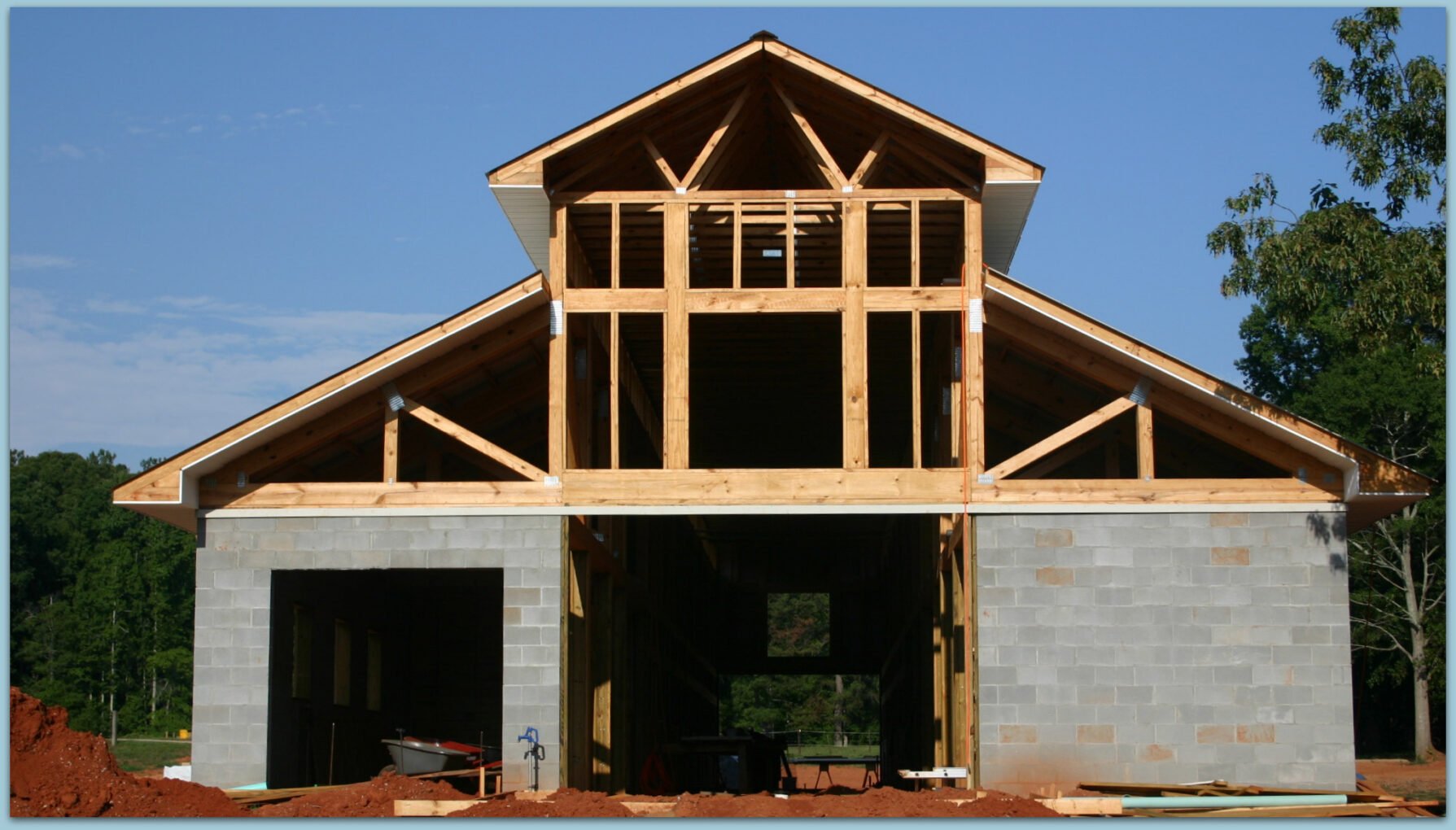 Under Construction - Photo View Of Twelve Stall Monitor Style Horse Barn Built With Concrete Blocks Metal Roof